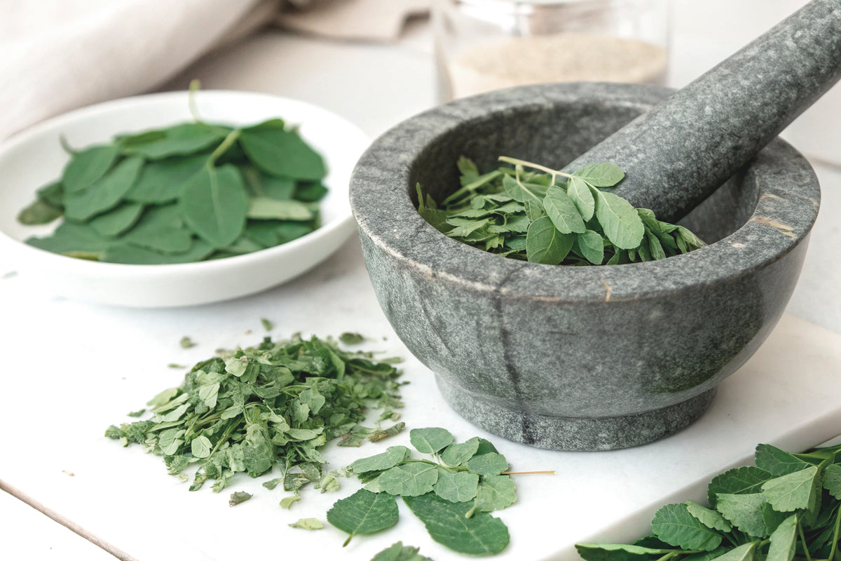 Moringa leaves in a mortar